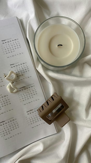 elegant accessories, candle, earrings, hair clip, beige fabric, magazine, flat lay, stylish, minimalistic, aesthetic, home decor