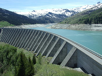 Gray Dam, Blue Sky, alpine landscape, snow-capped mountains, serene view, concrete dam, mountain scenery, natural beauty, water reservoir, outdoor scenery, dam structure