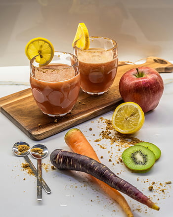 Fruit and Vegetable Spicy Smoothies, colorful smoothie, healthy ingredients, wooden board, apple, lemon, kiwi, carrots, spoons, spices, vibrant colors