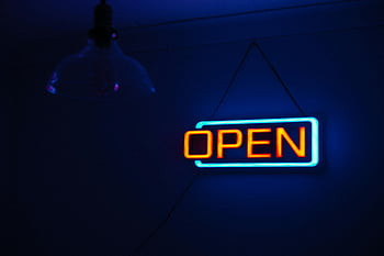 neon sign, open sign, yellow neon, teal neon, brightly lit, dark background, vibrant atmosphere, inviting atmosphere, neon signage, open neon sign, neon open sign