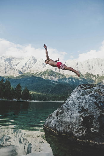 Lake Eibsee, Zugspitze mountains, diving, rock formation, white and red board shorts, adventurous dive, natural landscape, outdoor activity, scenic view, summer adventure, water jump
