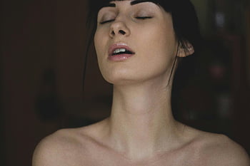 serene woman, eyes closed, tranquility, indoor, close-up, young woman, peaceful moment, natural beauty, soft lighting, calm expression, bare shoulders