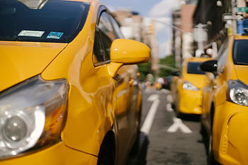 yellow taxis, city road, urban street, modern taxi cars, vibrant scene, bustling city, city life, taxi lineup, yellow cabs, city traffic, urban transportation