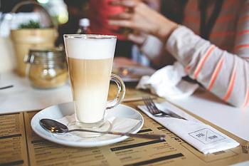 coffee latte, frothy milk, tall glass, stylish café, latte glass, cozy café, café setting, glass mug, latte art, café drink, coffee shop