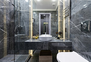 modern bathroom, marble walls, sleek fixtures, ambient lighting, luxury bathroom, contemporary design, glass shower, sink, toilet, decorative elements, ambient light