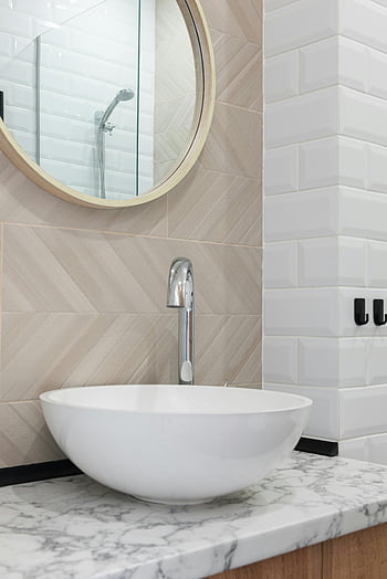 contemporary bathroom, white vessel sink, round mirror, marble countertop, washroom interior, sink and tap, modern bathroom design, white tiles, bathroom decor, bathroom sink, bathroom mirror