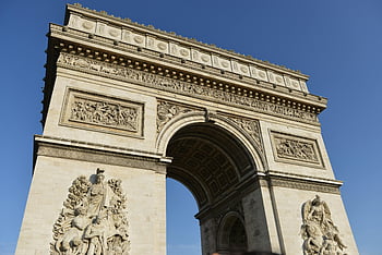 Arch De Triomphe, Paris, low angle shot, iconic Arc de Triomphe, clear blue sky, Paris landmark, French monument, historical architecture, European travel, Paris attractions, sunny day