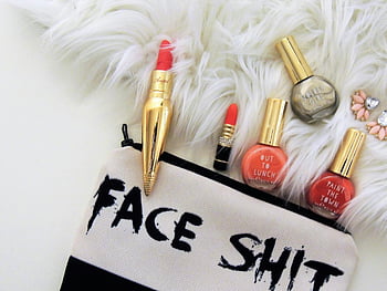 red lipsticks, nail polish bottles, luxury beauty products, furry background, bold makeup pouch, flat lay, assorted-color nail polish, makeup accessories, beauty flatlay, cosmetic products, stylish makeup setup