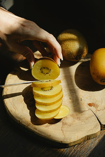 golden kiwi, wooden board, healthy eating, fresh ingredients, slicing kiwi, fresh kiwi, healthy food, kiwi slices, wooden cutting board, cooking, fruit preparation