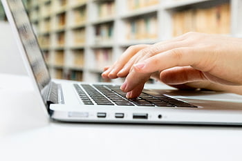 typing, hands, laptop keyboard, library setting, close-up, person typing, laptop, keyboard, library, study, work