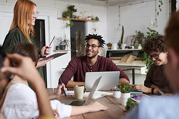 team meeting, diverse group, professionals, modern office, laptops, productive meeting, office space, collaborative work, business people, workplace environment, group discussion