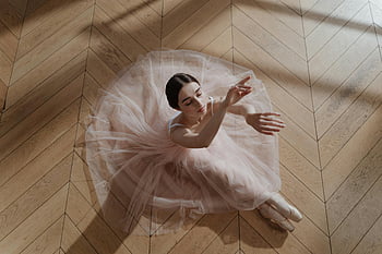 ballerina, pink tutu, wooden floor, graceful pose, above view, ballet dancer, tutu skirt, ballet performance, artistic photography, dance art, floor pose