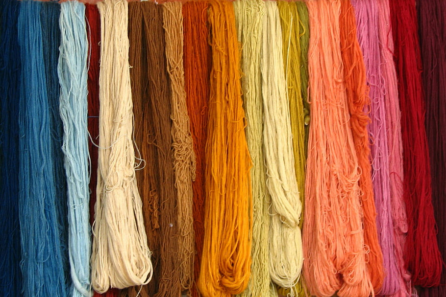 multi-colored laces, textile yarns, diverse colors, vivid assortment, hanging rows, colorful laces, yarn display, textile display, colorful yarns, yarn assortment, textile colors