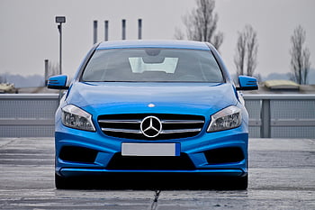 blue Mercedes-Benz, parked car, front view, wet street, cloudy skies, blue car, Mercedes-Benz car, street parking, car photography, automotive photography, vehicle exterior