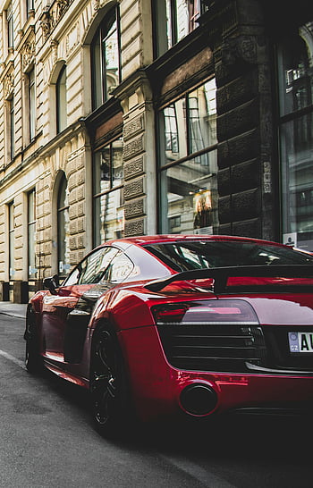 red sports car, Prague, historic street, urban elegance, powerful design, sleek red car, parked car, charming street, red vehicle, road, cityscape