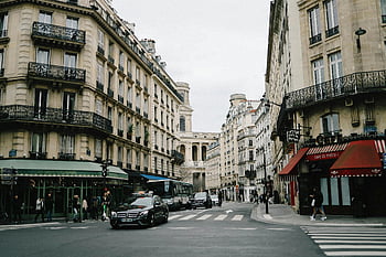 Paris street, classic architecture, busy pedestrians, French charm, urban crossroads, lively street, iconic French, cityscape, European city, street scene, Parisian life