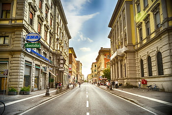 people walking, street scene, urban street, cityscape, pedestrians, architecture, buildings, sunny day, European city, Assitalia sign, bicycles