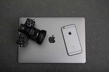 DSLR camera, MacBook, iPhone, modern technology, textured surface, high-angle shot, technology essentials, black background, close-up, photo equipment, electronic devices