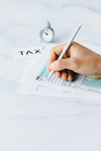 tax forms, filing taxes, financial deadline, time urgency, hand writing, pen, tax documents, 1040 form, tax preparation, clock, paperwork