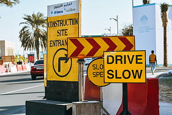 modern city, yellow warning signs, roadwork, construction site, caution signs, drive slow, city street, traffic signs, safety, urban road, road construction