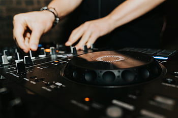 DJ, mixer, close-up, professional mixer, club setting, music mixing, expert DJ, turntable, audio equipment, nightlife, entertainment