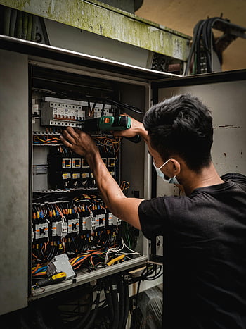 circuit breaker, technician, electrical wires, indoor work, panel adjustment, electrical panel, circuit breaker switch, electrical technician, indoor electrical work, circuit breaker panel, electrical maintenance