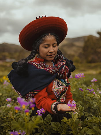 Peruvian woman, traditional clothing, Cusco field, flowers, young woman, cultural attire, Andean culture, indigenous fashion, natural landscape, floral field, traditional hat