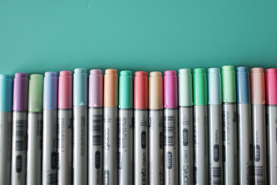 assorted-color marking pens, vibrant pastel art markers, turquoise background, horizontal arrangement, colorful markers, art supplies, pastel colors, marker lot, creative tools, stationery, drawing markers