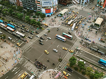 aerial photography, cars, road intersection, busy city street, traffic, pedestrians, urban life, cityscape, transportation, public buses, crosswalks