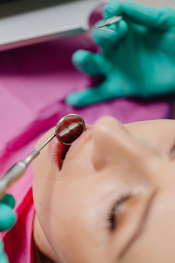 dental treatment, close-up view, dental examination, patient, dentist tools, dental mirror, dental instruments, dental care, dental hygiene, dental check-up, dental procedure