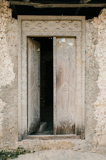 abandoned building, destroyed building, opened door, ornate wooden door, weathered wooden door, old stone wall, historical door, rustic architecture, ancient building, decayed structure, architectural ruins