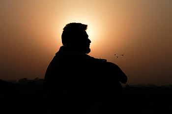 silhouette photo, man silhouette, golden sunset, peaceful scene, reflective scene, profile view, sunset silhouette, man sitting, stunning sunset, sunset photo, silhouette photography