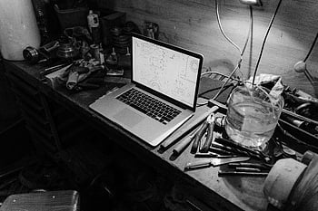 grayscale photo, laptop, work table, workshop, blueprints, tools, workbench, black and white, workshop tools, blueprint display, workshop environment
