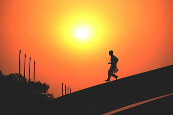 man running, orange sunset, Dhaka Bangladesh, dramatic silhouette, golden hour, sunset sky, road, silhouette photography, outdoor activity, evening light, sunset scene