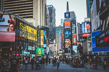 Times Square, New York City, crowds, skyscrapers, iconic billboards, bustling daytime, intersection, people crossing, urban scene, city life, LG