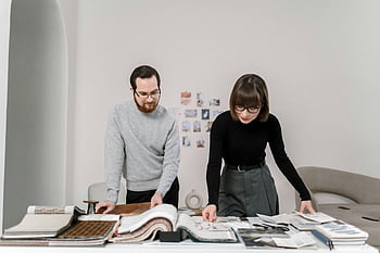 fabric swatches, interior design, man and woman, reviewing fabrics, engaged couple, design project, textile samples, material selection, collaborative work, creative process, professional meeting