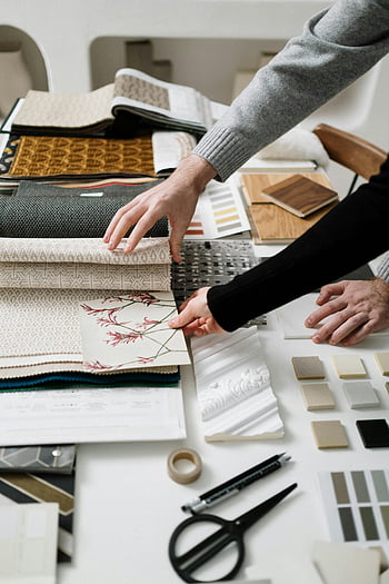 fabric selection, interior design, fabric patterns, hands selecting, close-up hands, design project, textile samples, material choices, color swatches, design tools, fabric textures