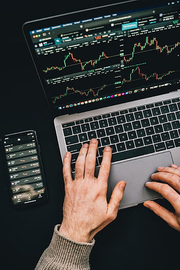 Hands on laptop, cryptocurrency charts, digital finance, smartphone display, typing hands, laptop keyboard, financial analysis, stock market, trading charts, tech finance, online trading