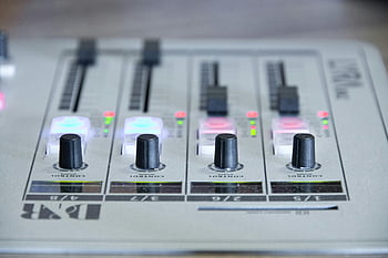 audio mixer, sound adjustment, control sliders, knobs, detailed view, white and black equalizer, music production, audio equipment, sound mixing, studio equipment, audio controls