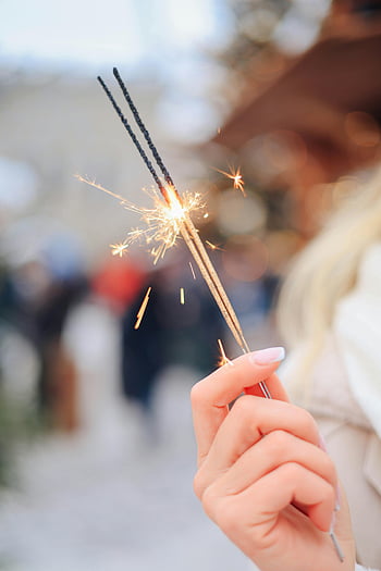 woman holding sparkler, close-up, winter festivity, outdoor, lit sparkler, hand, celebration, festive, sparklers, winter, outdoors