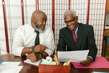 men in corporate attire, smiling men, business attire, positive interaction, office setting, senior men, discussing documents, professional meeting, business conversation, office discussion, corporate environment