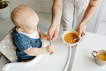 baby, high chair, parent feeding, family moment, cute baby, spoon, mealtime, baby food, warm family, feeding time, baby in high chair