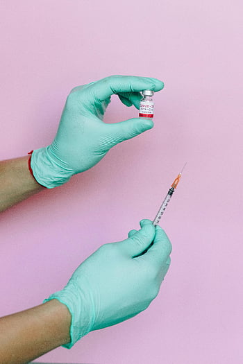 COVID-19 vaccine, syringe, hands, gloves, pink background, close-up, medical, healthcare, vaccination, preparation, vial