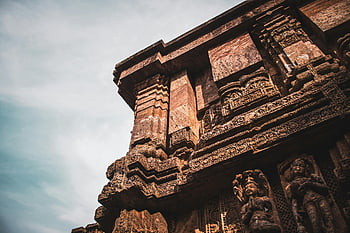 Konark Sun Temple, stone carvings, Hindu temple, cloudy sky, heritage site, India, intricate carvings, temple facade, historical temple, stone sculptures, architectural details
