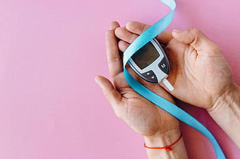 blood glucose meter, blue ribbon, diabetes awareness, pink background, hands holding, glucometer, health, medical device, diabetes symbol, healthcare, awareness ribbon