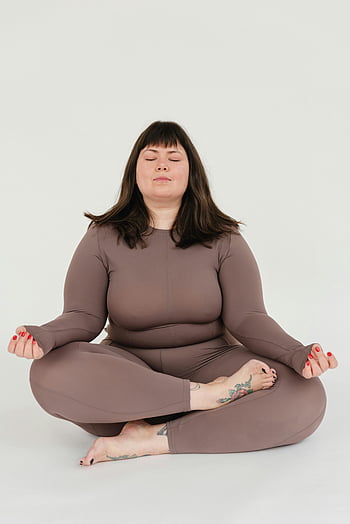 serene, plus size, female, meditating, Lotus pose, activewear, white background, meditation, yoga, tattoo, feet