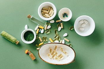pose à plat, médicaments alternatifs, suppléments à base de plantes, Suppléments pharmaceutiques, bols en céramique, fond vert, vue de dessus, vitamines, des pilules, capsules, remèdes naturels