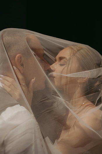 couple kissing, wedding veil, intimate moment, close-up, romantic couple, bride and groom, romantic kiss, wedding photography, romantic scene, wedding couple, veil kiss