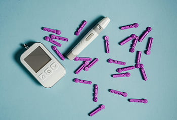 blood glucose meter, lancets, lancing device, blood sugar measurements, flat lay, blue background, diabetes tools, medical devices, health monitoring, glucose testing, diabetes management