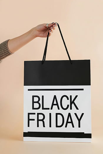 Black Friday, shopping bag, hand holding, peach background, marketing, black and white, Black Friday bag, shopping, sale, retail, consumerism